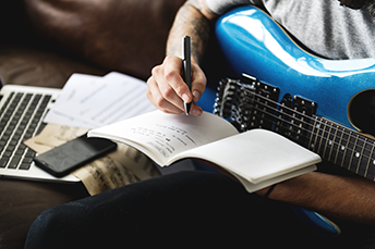 Blue guitar and man songwriting